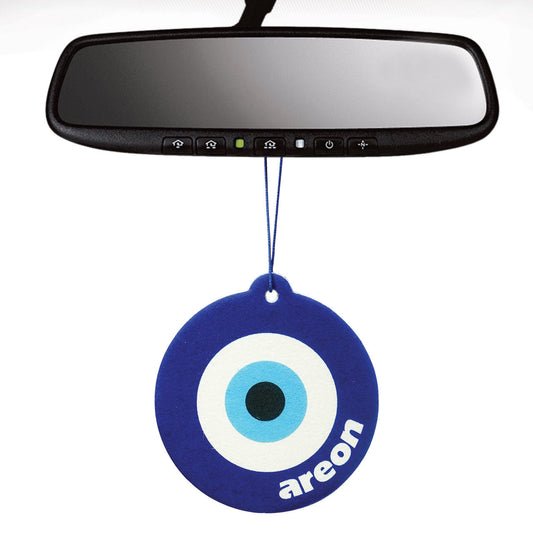 Car air freshener with evil eye design hanging from a car's rearview mirror.