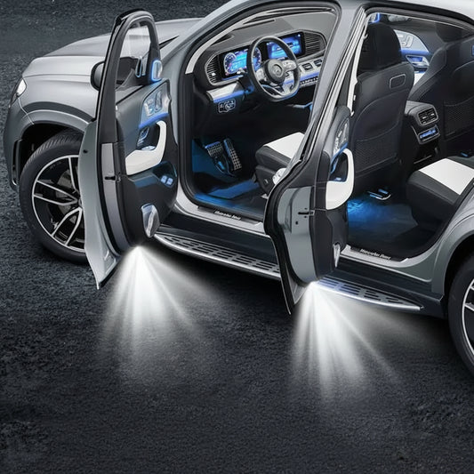 Car interior with open doors and illuminated floor, featuring a logo.