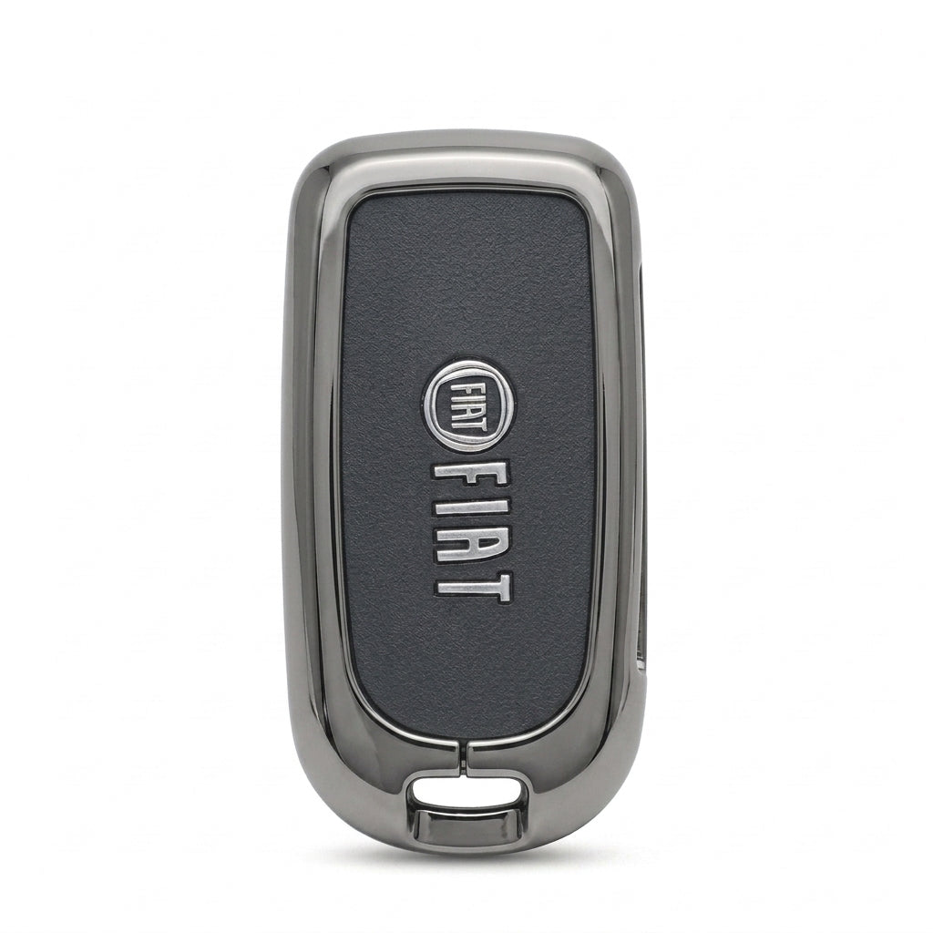 A Fiat key fob cover or decorative shell with a dark textured center panel and polished silver metallic border, shown on a plain white background.