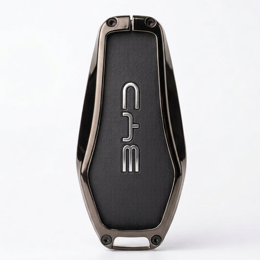 A sleek, metallic dark gray key fob or keychain with a textured black center panel featuring the vertical silver logo BYD. The product is photographed on a clean, light gray background with a soft shadow underneath.