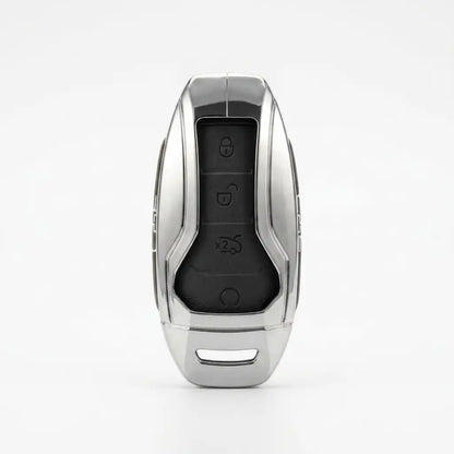 A silver metallic BYD METAL KEY COVER with a black central panel featuring lock, unlock, trunk, and panic buttons, shown on a clean white background.