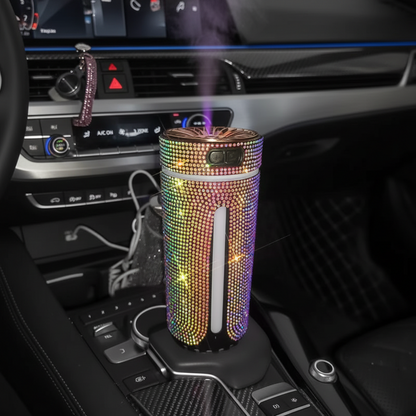 Decorative diffuser with colorful rhinestones on a car dashboard