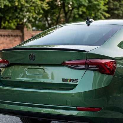 Rear three-quarter view of a metallic green Skoda VRS Logo/Emblem