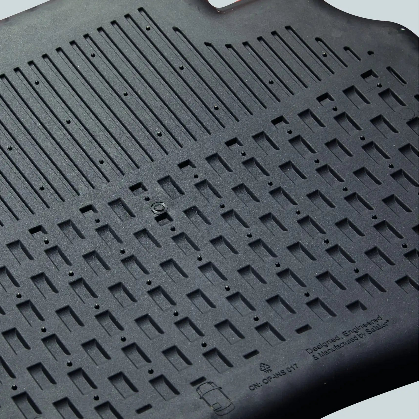 Black rubber mat with textured surface on a light gray background