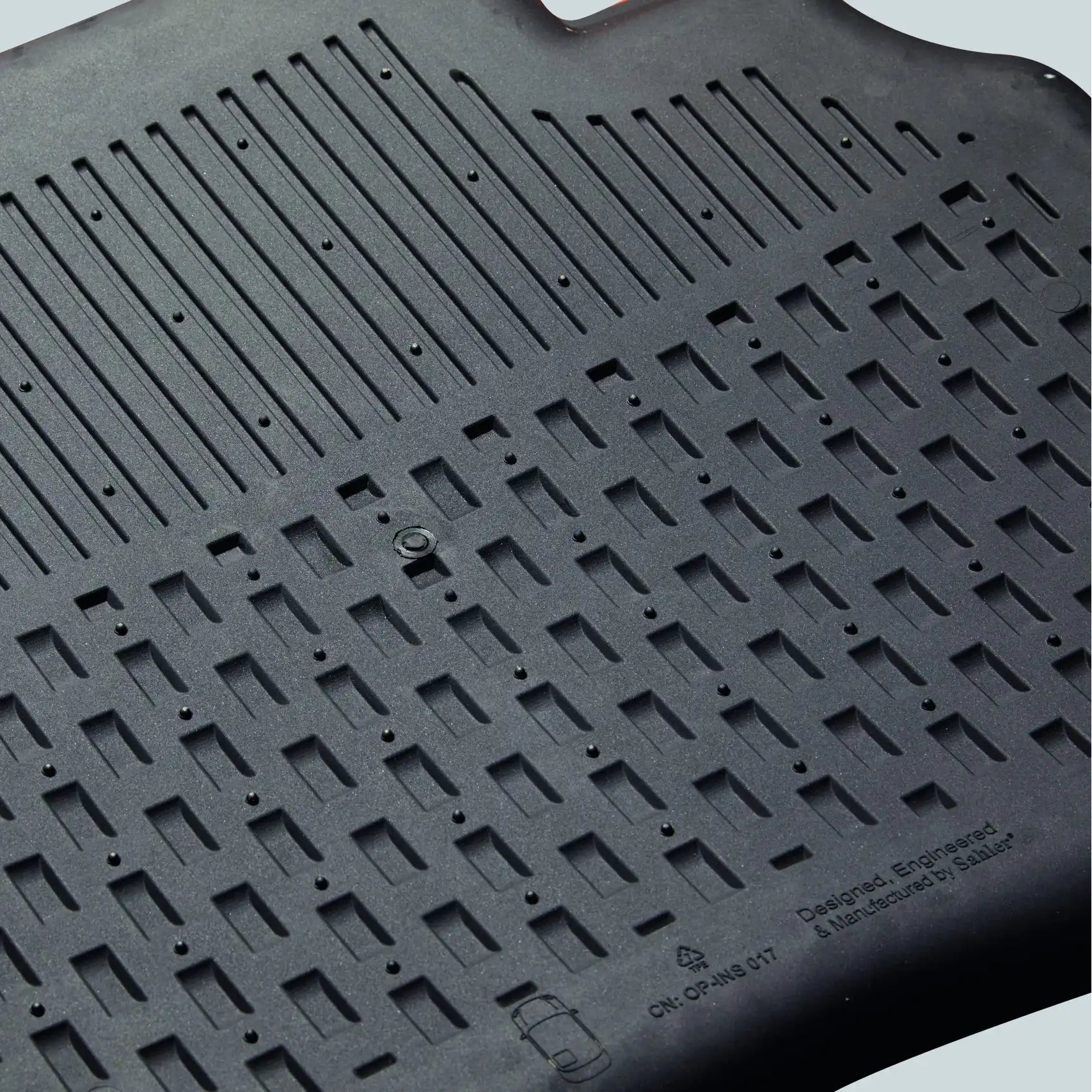 Black rubber mat with textured surface on a light gray background