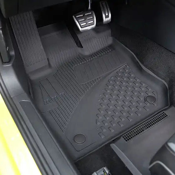 Car interior with black floor mat on a yellow vehicle