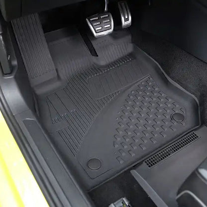 Car interior with black floor mat on a yellow vehicle
