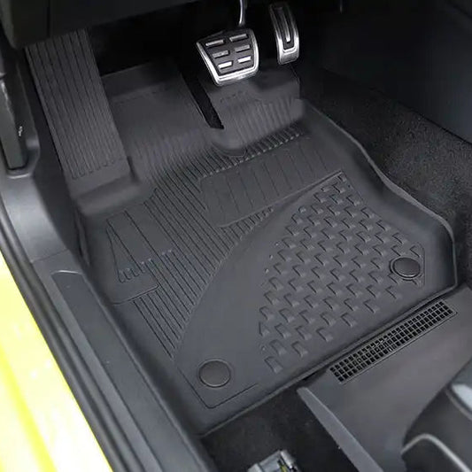 Car interior with black floor mat on a yellow vehicle
