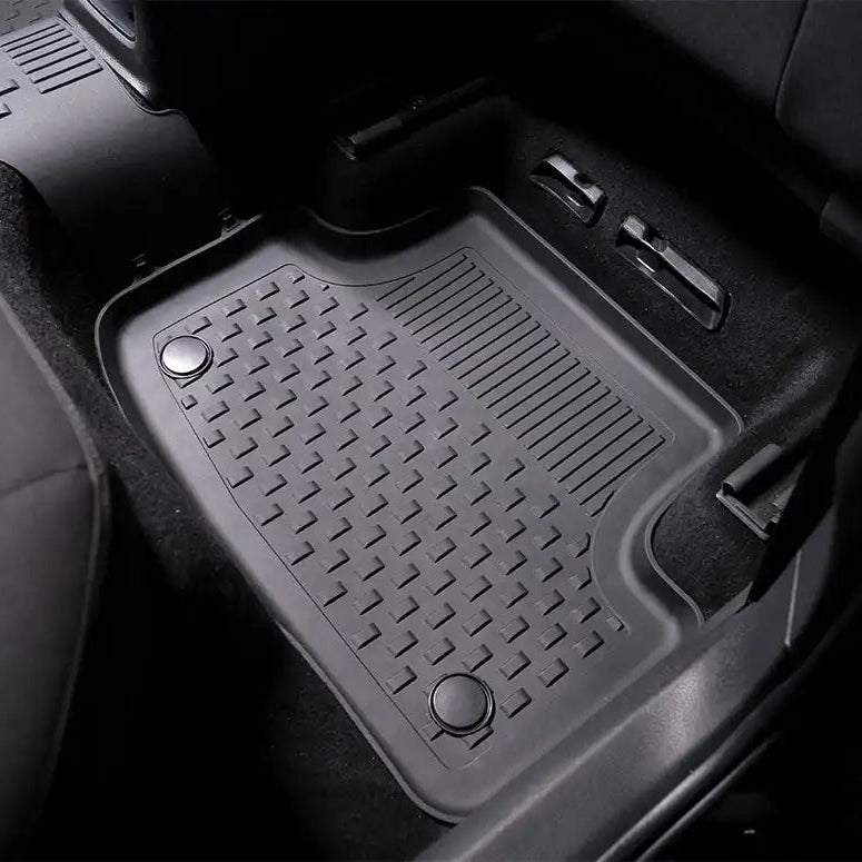 Car floor mat with a textured pattern on a black car interior background