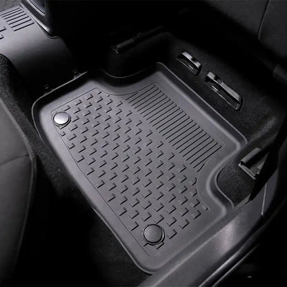 Car floor mat with a textured pattern on a black car interior background