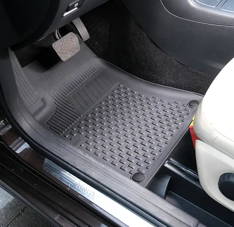 Car floor mat with brand logo on a vehicle interior